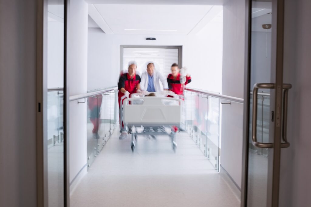 doctors pushing emergency stretcher bed corridor